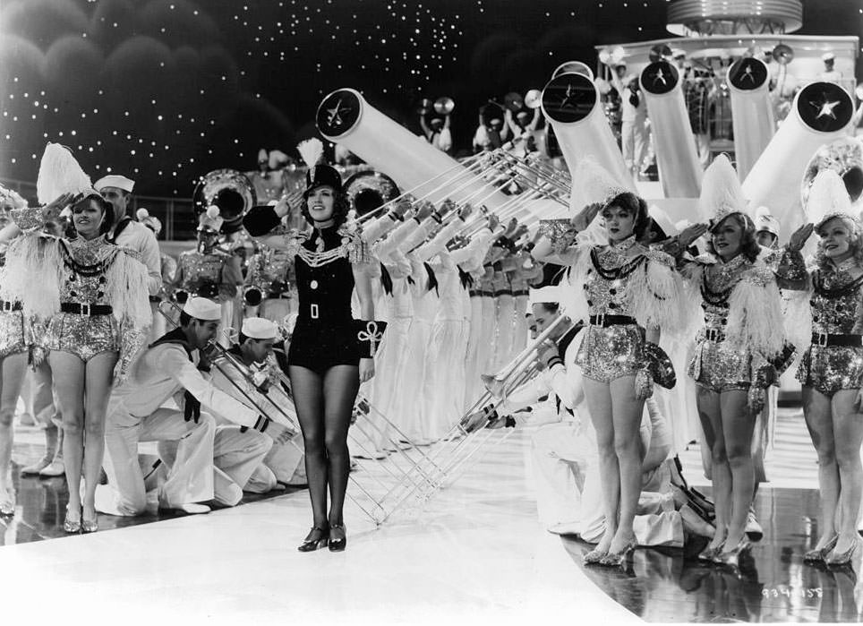 Eleanor Powell gives a salute with many other performers in a scene from the film 'Born To Dance', 1936.