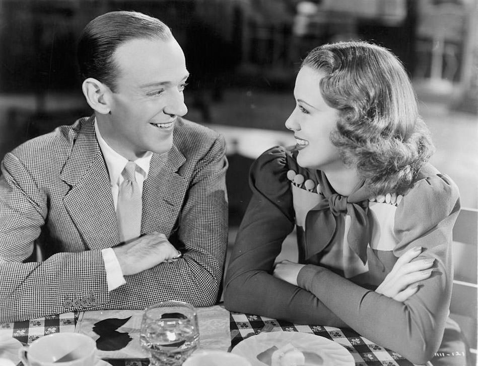 Eleanor Powell and Fred Astair share a smile at the table in a scene from the film 'Broadway Melody Of 1940',