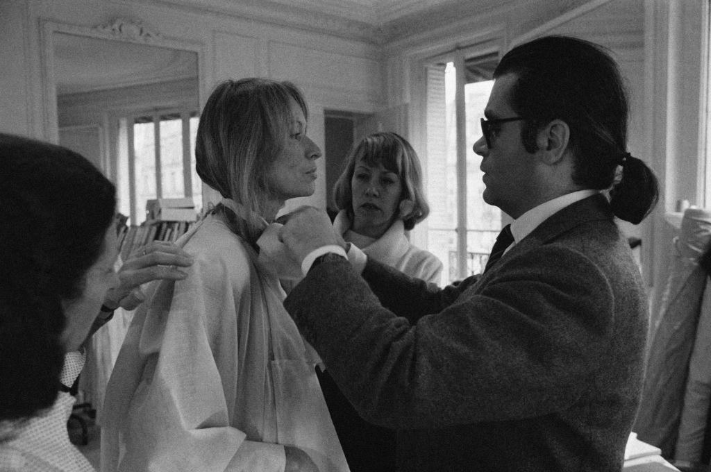 Karl Lagerfeld fixing a model's collar, 1979.