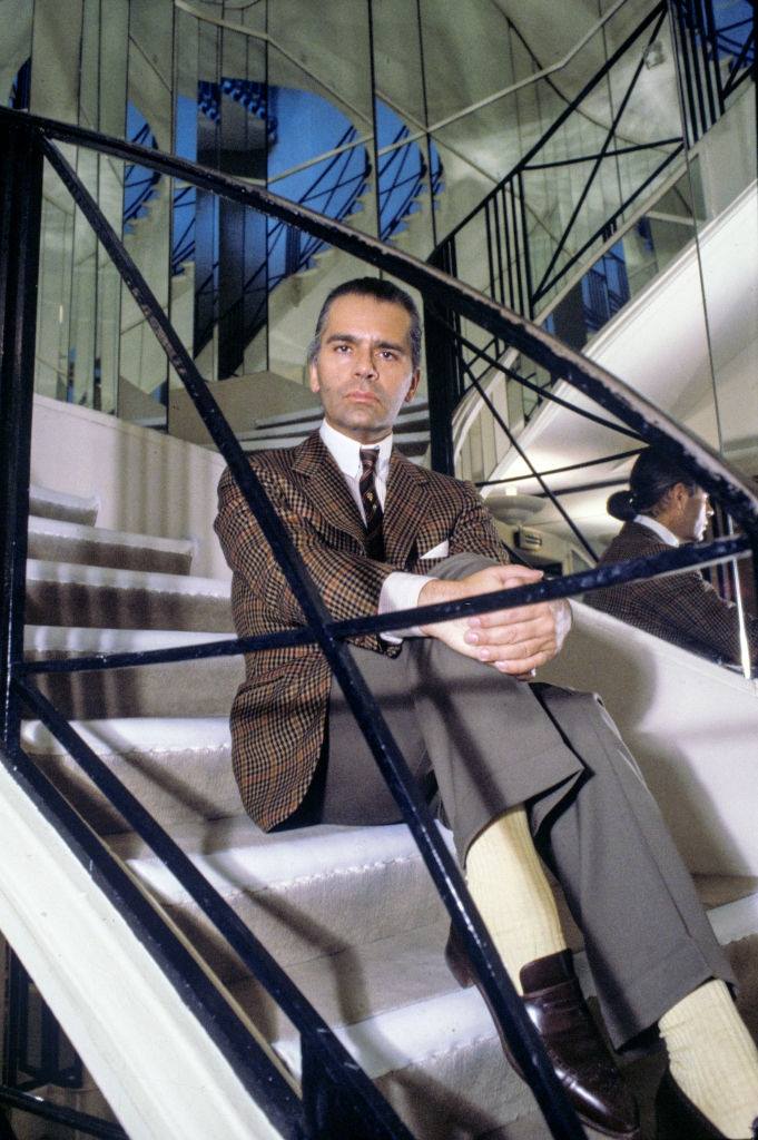 Karl Lagerfeld, posing on the steps of the Chanel store, 1983.