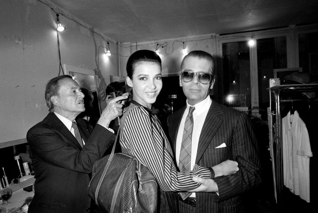 Karl Lagerfeld with a model as French hairdresser Alexandre de Paris, 1983.