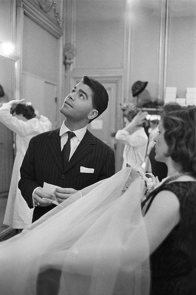 Karl Lagerfeld settles the last details on the veil presented to him by an employee, 1959.