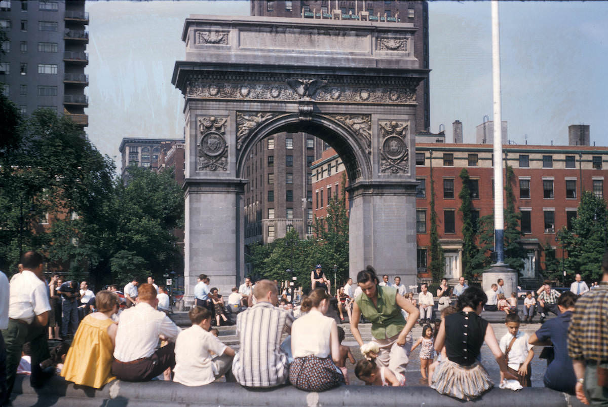 People gathered beneath Washington Square Park Arch, 1956