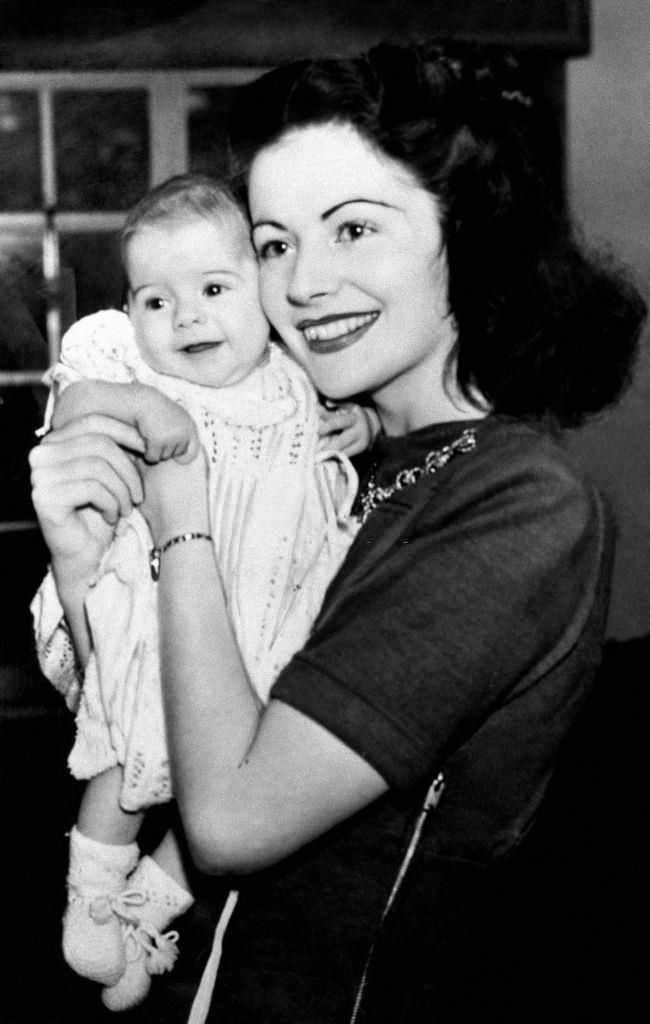 Margaret Lockwood with her baby, Margaret Julia Leon, at their Hampshire home, 1943.