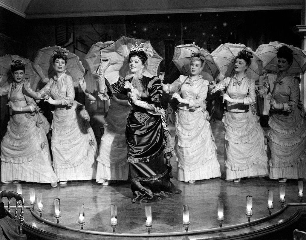 Margaret Lockwood holding a parasol and singing in the film Laughing Anne, 1948.