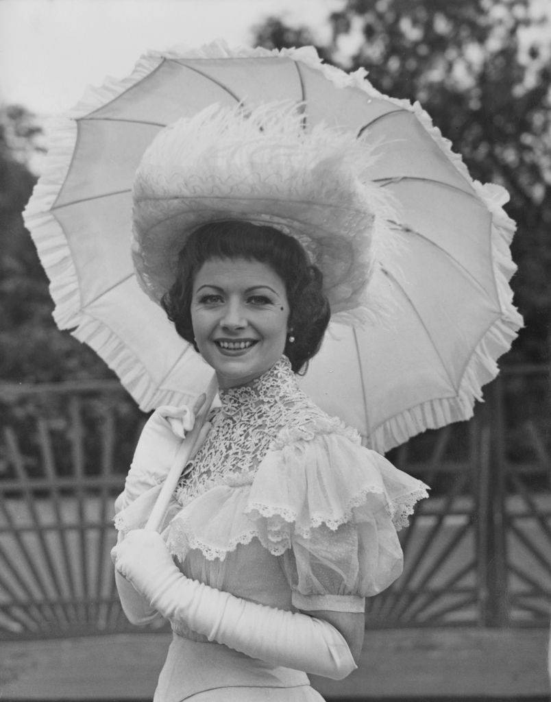 Margaret Lockwood wearing period fashion to the Theatrical Garden Party at the Chelsea Royal Hospital, 1951.