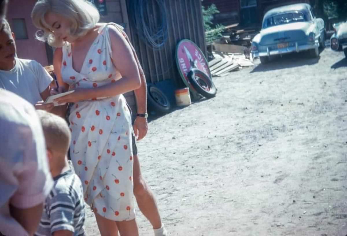 Marilyn Monroe signing autographs for her fans in a series of Candid Photographs