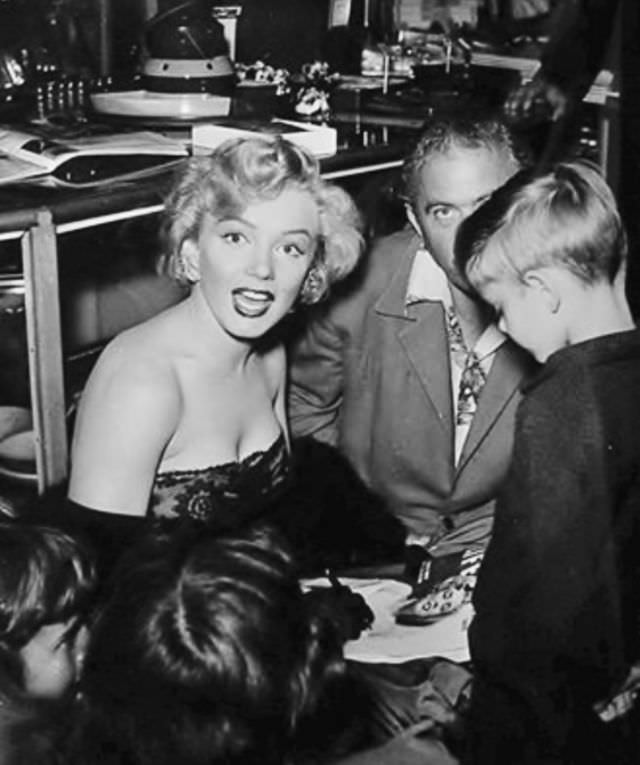 Marilyn Monroe signing autographs for her fans in a series of Candid Photographs