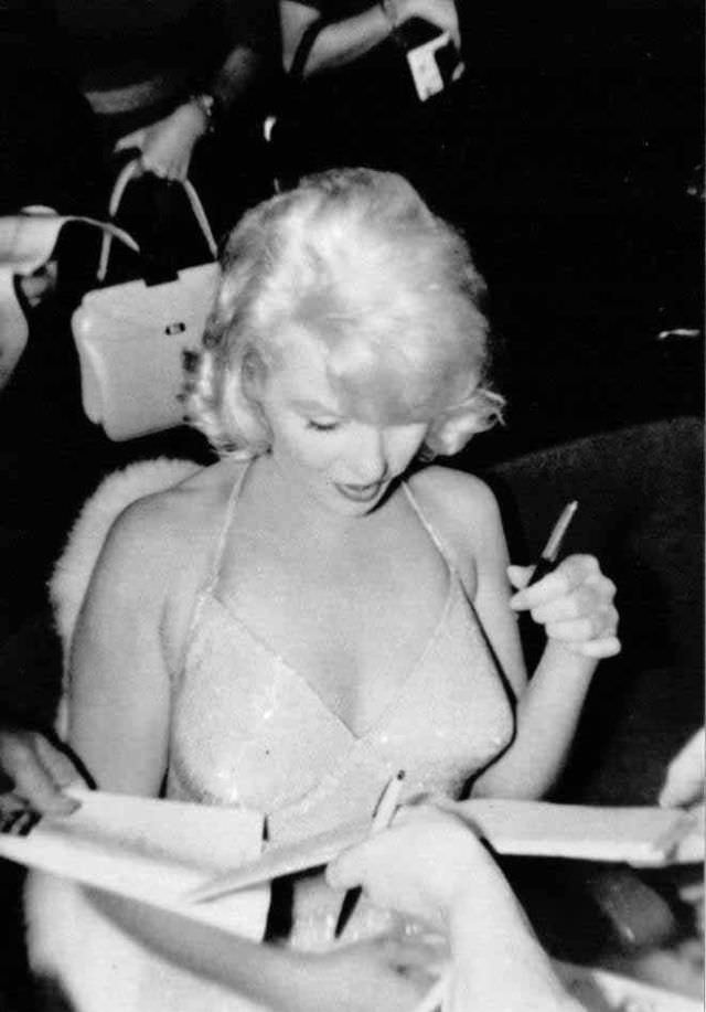 Marilyn Monroe signing autographs for her fans in a series of Candid Photographs