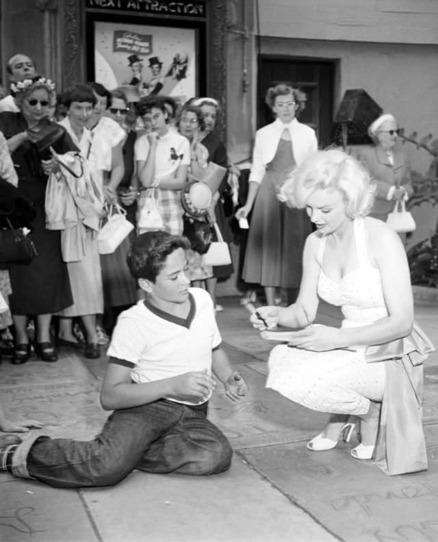 Marilyn Monroe signing autographs for her fans in a series of Candid Photographs