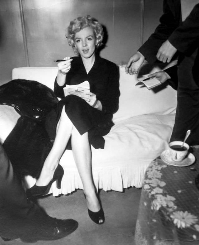 Marilyn Monroe signing autographs for her fans in a series of Candid Photographs