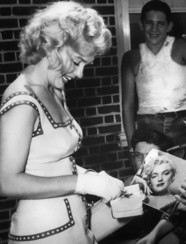 Marilyn Monroe signing autographs for her fans in a series of Candid Photographs