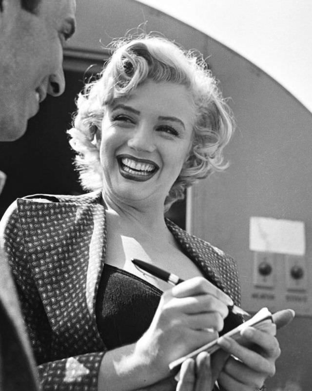 Marilyn Monroe signing autographs for her fans in a series of Candid Photographs