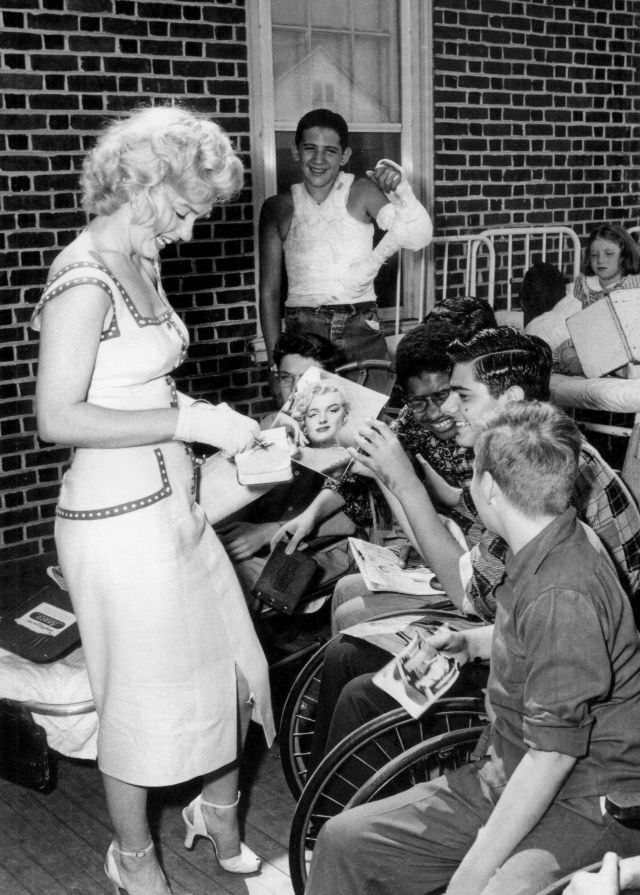 Marilyn Monroe signing autographs for her fans in a series of Candid Photographs