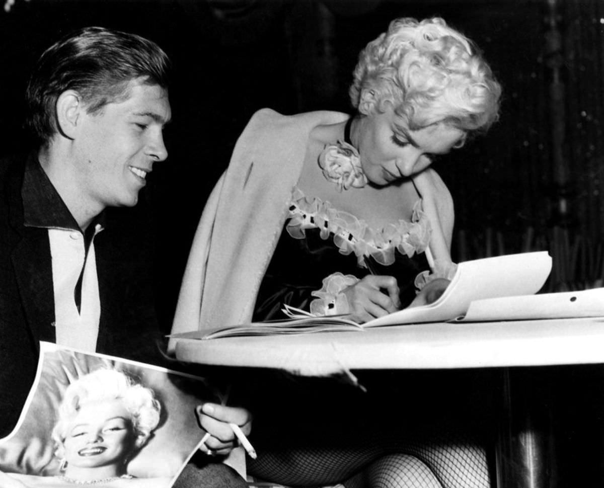 Marilyn Monroe signing autographs for her fans in a series of Candid Photographs