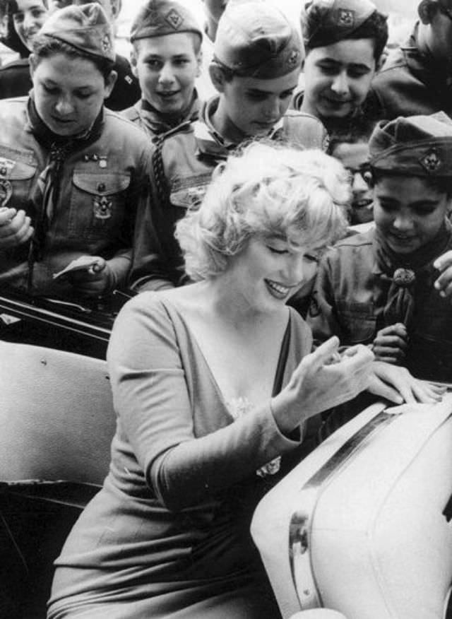 Marilyn Monroe signing autographs for her fans in a series of Candid Photographs