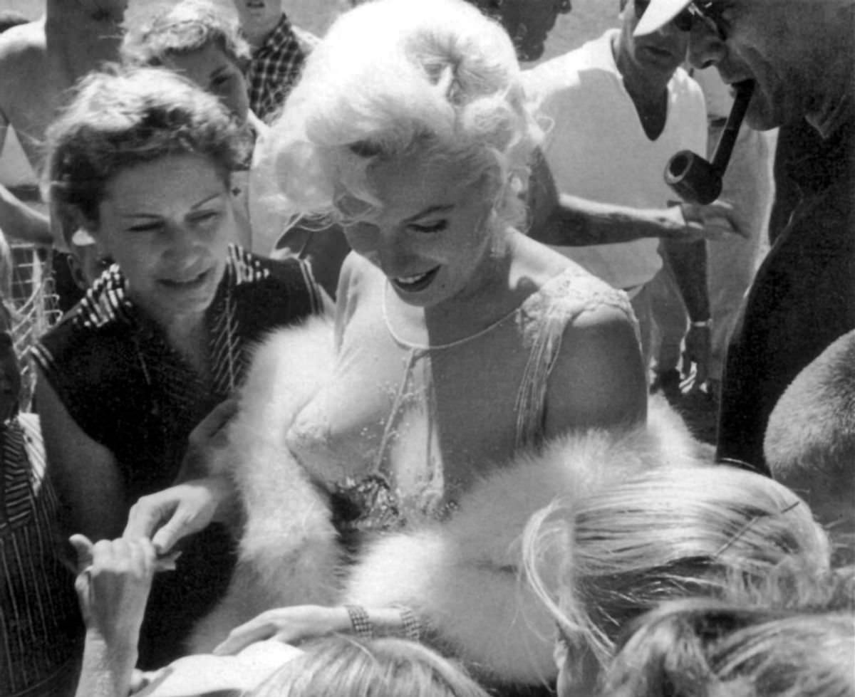 Marilyn Monroe signing autographs for her fans in a series of Candid Photographs