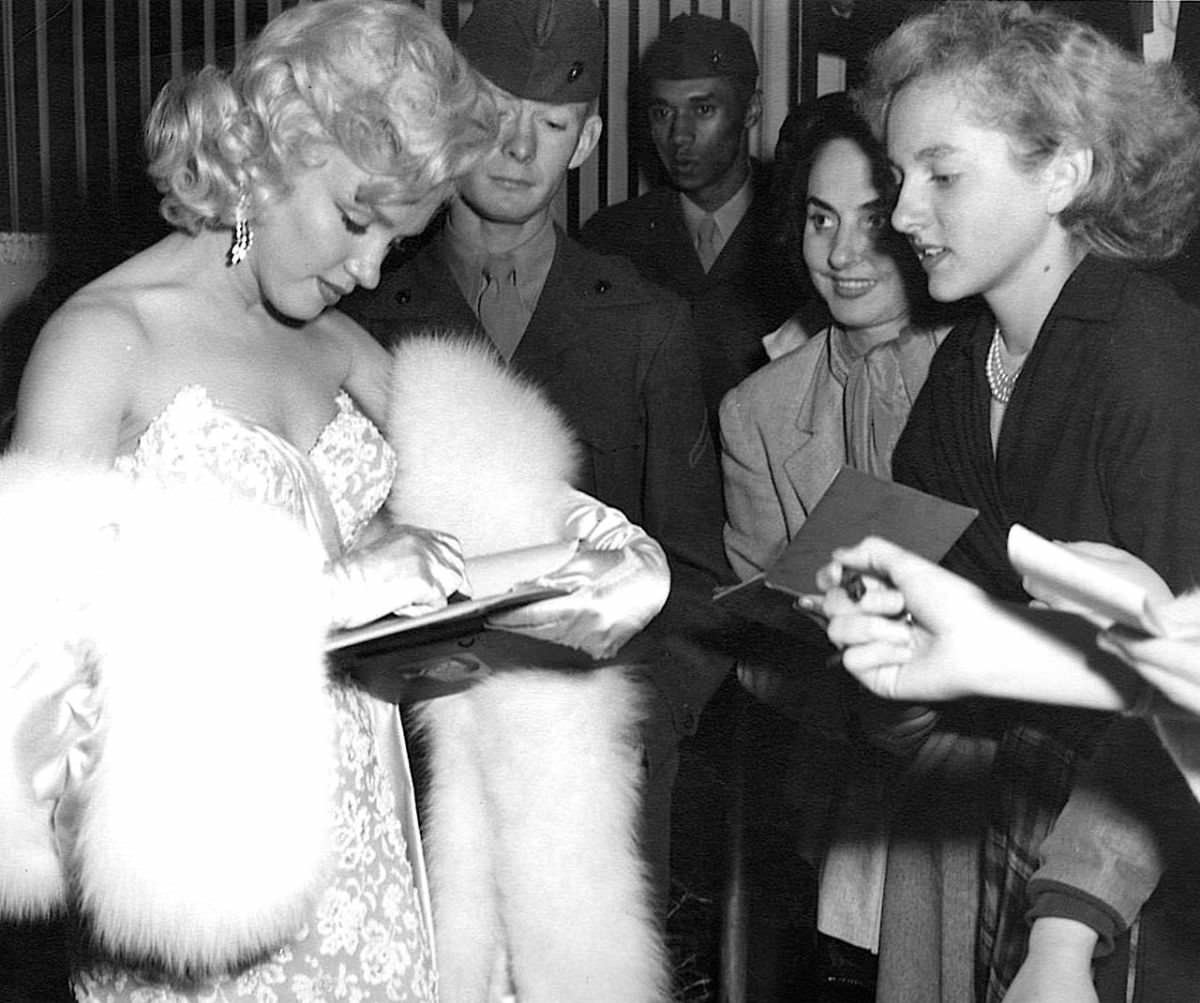 Marilyn Monroe signing autographs for her fans in a series of Candid Photographs