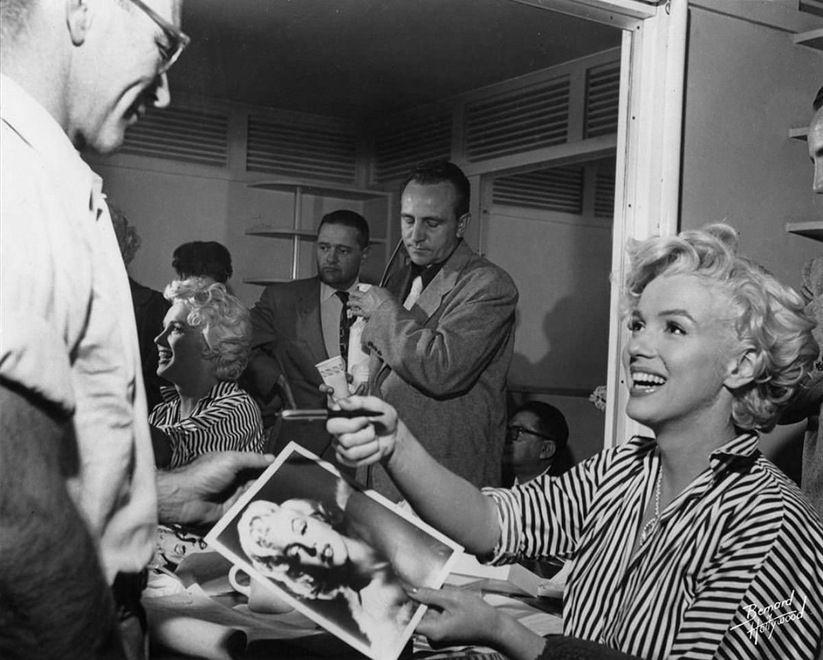 Marilyn Monroe signing autographs for her fans in a series of Candid Photographs