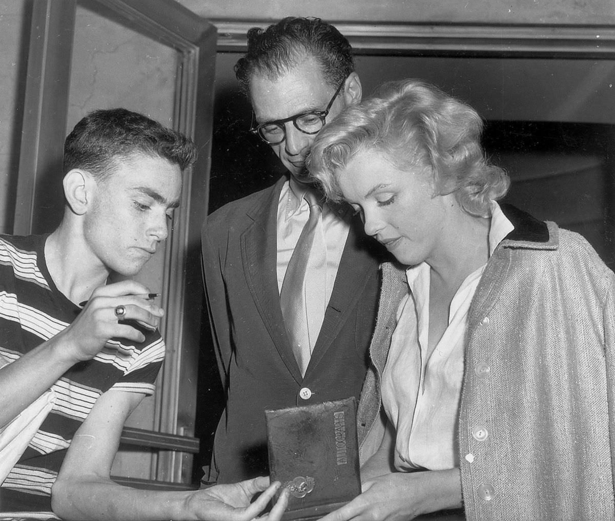 Marilyn Monroe signing autographs for her fans in a series of Candid Photographs