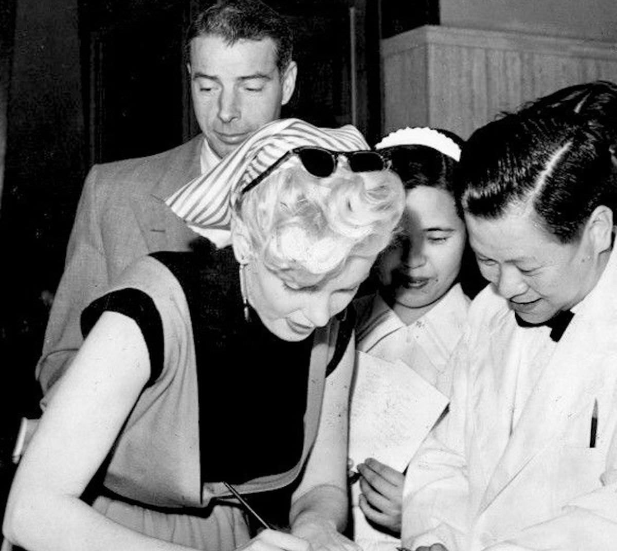 Marilyn Monroe signing autographs for her fans in a series of Candid Photographs