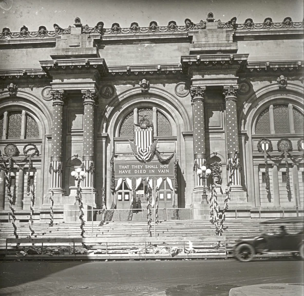 Columns wrapped and a banner above the doorway: “THAT THEY SHALL NOT HAVE DIED IN VAIN.”