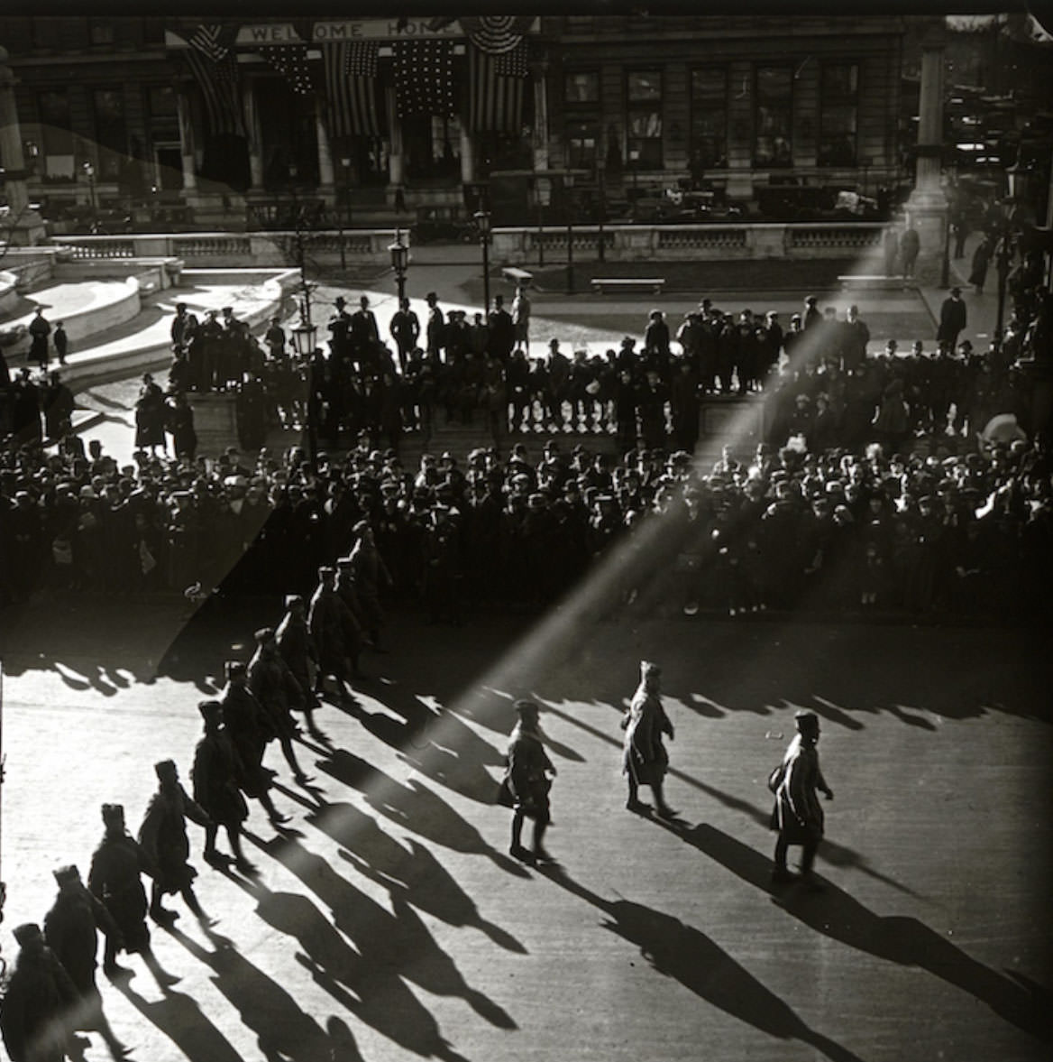 Late in the parade, as the sun was low in the sky. That might be, at top left, the Pulitzer Fountain in Grand Army Plaza, outside the Plaza Hotel.