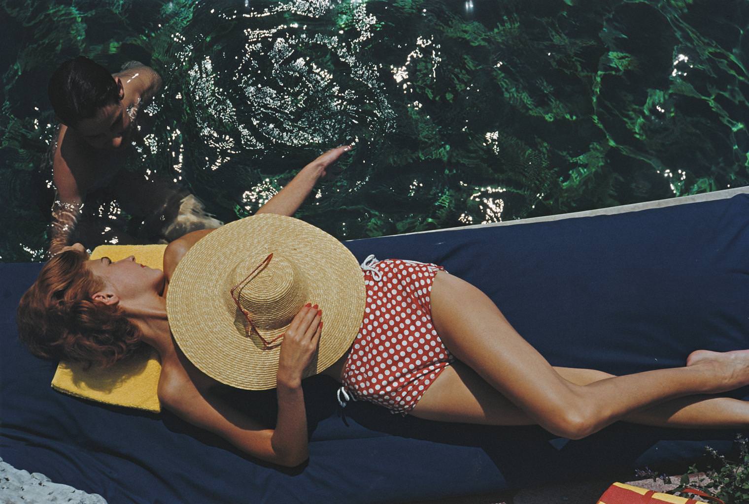 Lillian Hanson relaxes by the swimming pool at the Bürgenstock Estate, Lake Lucerne, Switzerland, 1955.