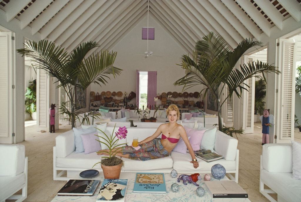 Yale student Edith Hansel lying on a sofa, Casa de Campo, Dominican Republic, circa 1990