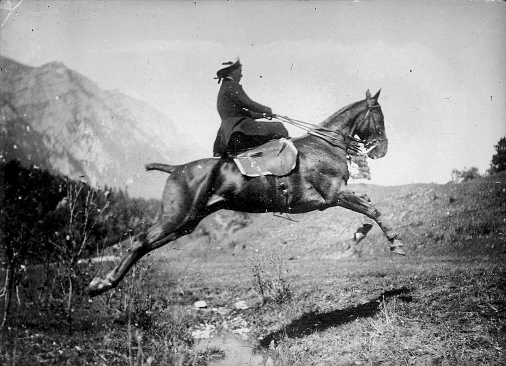Princess Marie of Romania jumps a horse over a very shallow creek, early 20th century.