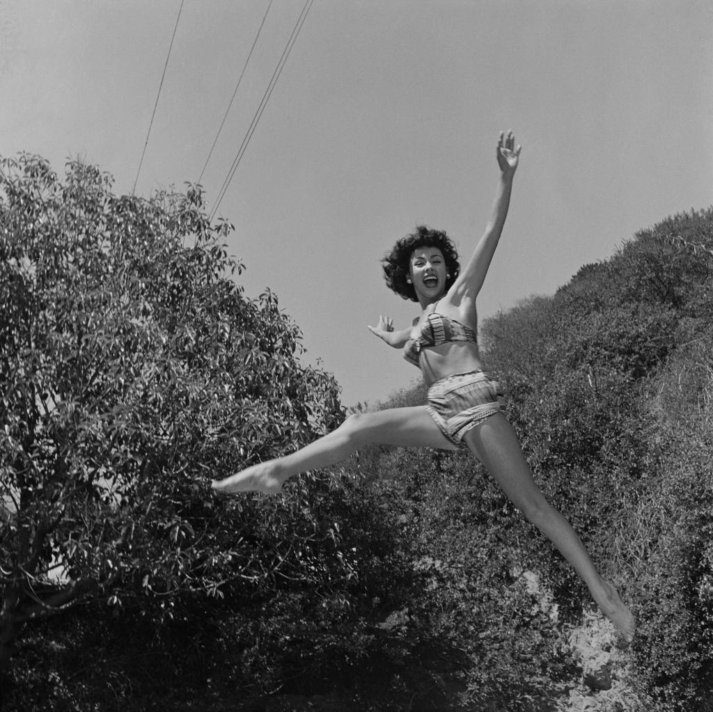 Rita Moreno jumping in a bikini, 1951.
