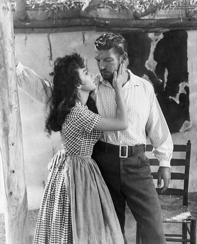 Rita Moreno getting close to Richard Egan in a scene from the film 'Untamed', 1955.