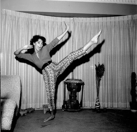 Rita Moreno dancing in her home, 1957. Bygonely