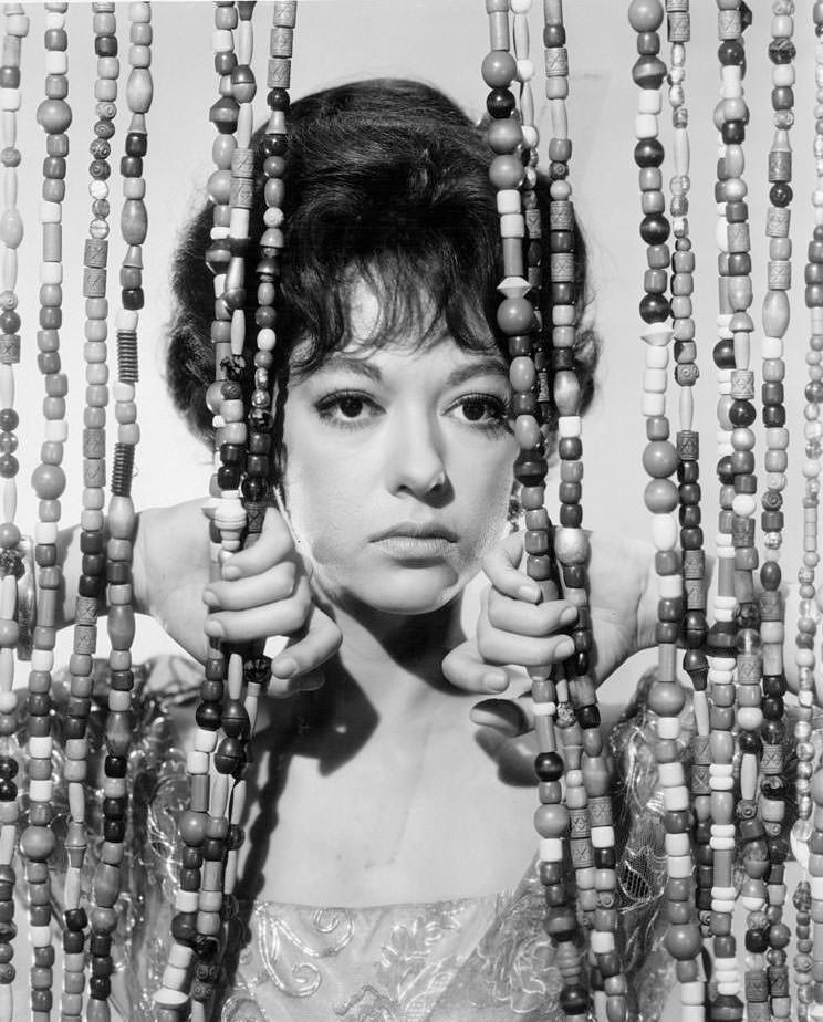 Rita Moreno behind a beaded curtain in a scene from the film 'A Summer And Smoke', 1961.