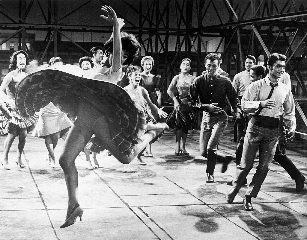 Rita Moreno dancing with cast of West Side Story, 1961.