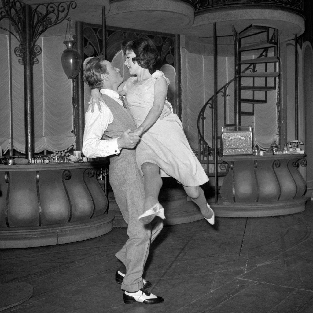 Rita Moreno is swept off her feet by Gary Miller as they rehearse a tango at the Lyric Theatre for a scene in the musical 'She Loves Me', 1964.