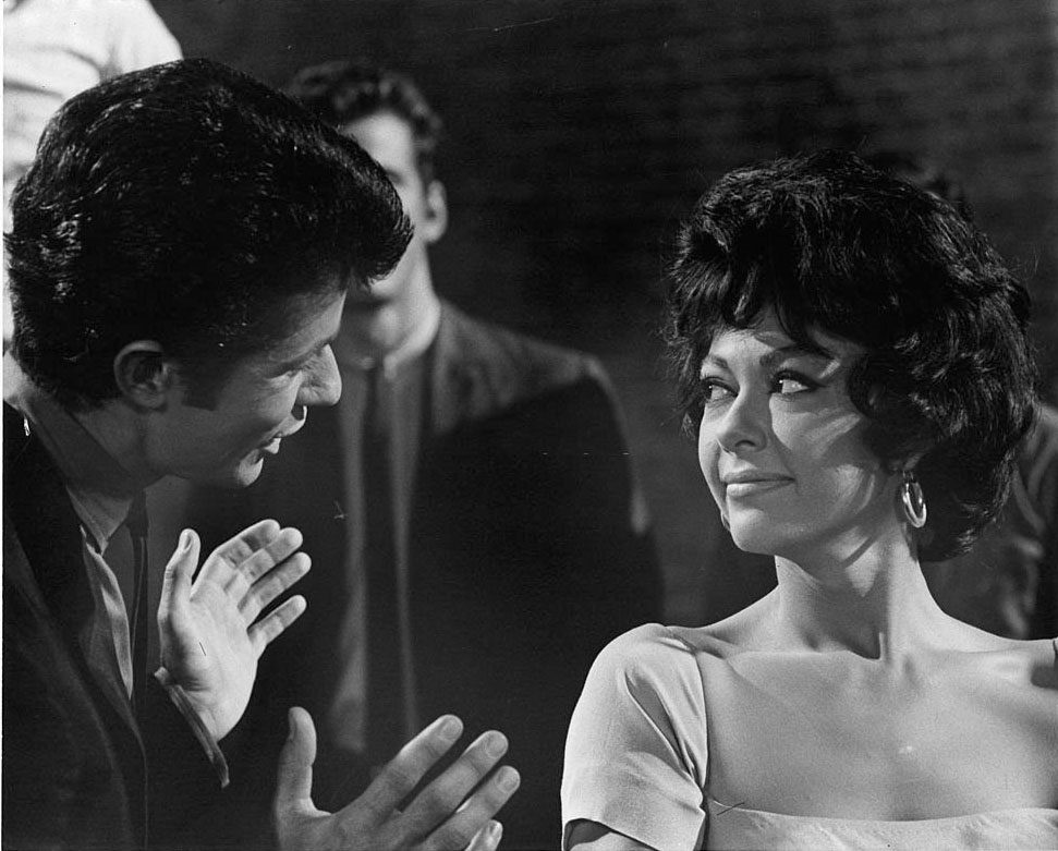 Rita Moreno listens while George Chakiris speaks with her in a scene from the film 'West Side Story', 1961.