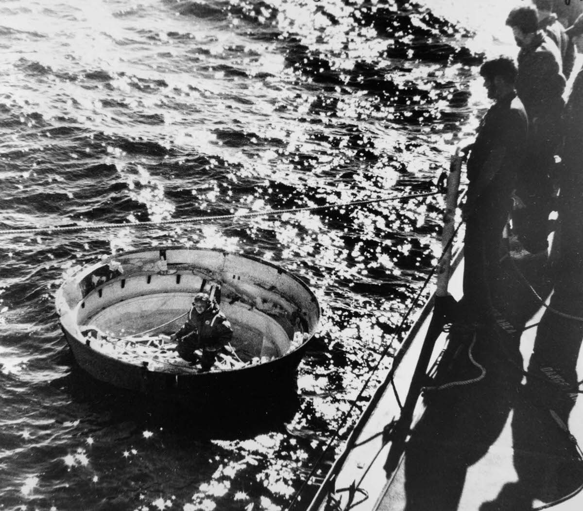 Coast Guardsmen prepare to hoist the fulcrum of a solid rocket booster out of the ocean during Challenger salvage operations. Jan. 31, 1986.