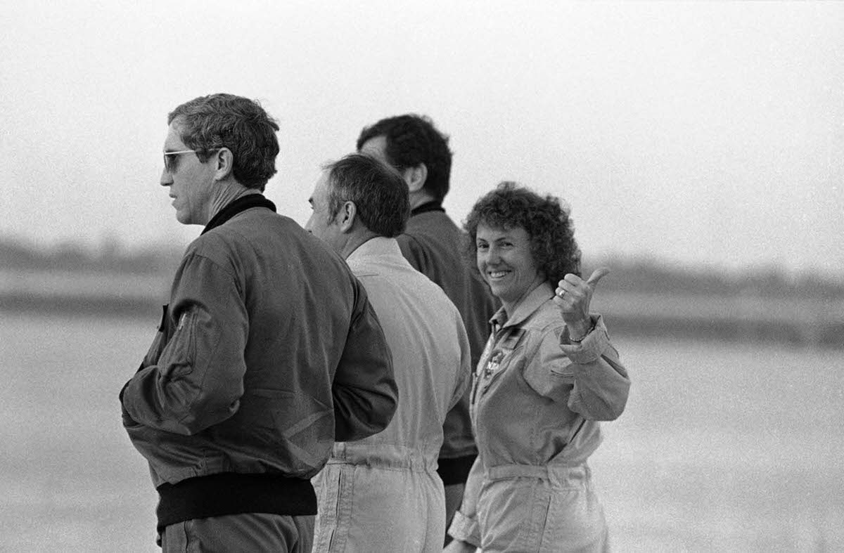 Christa McAuliffe gives a thumbs-up as she prepares for a test flight at Kennedy Space Center. Jan. 24, 1986.