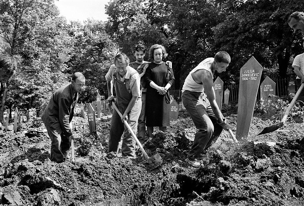 Gravediggers at work in the Lion Cemetery, Sarajevo, 1992.
