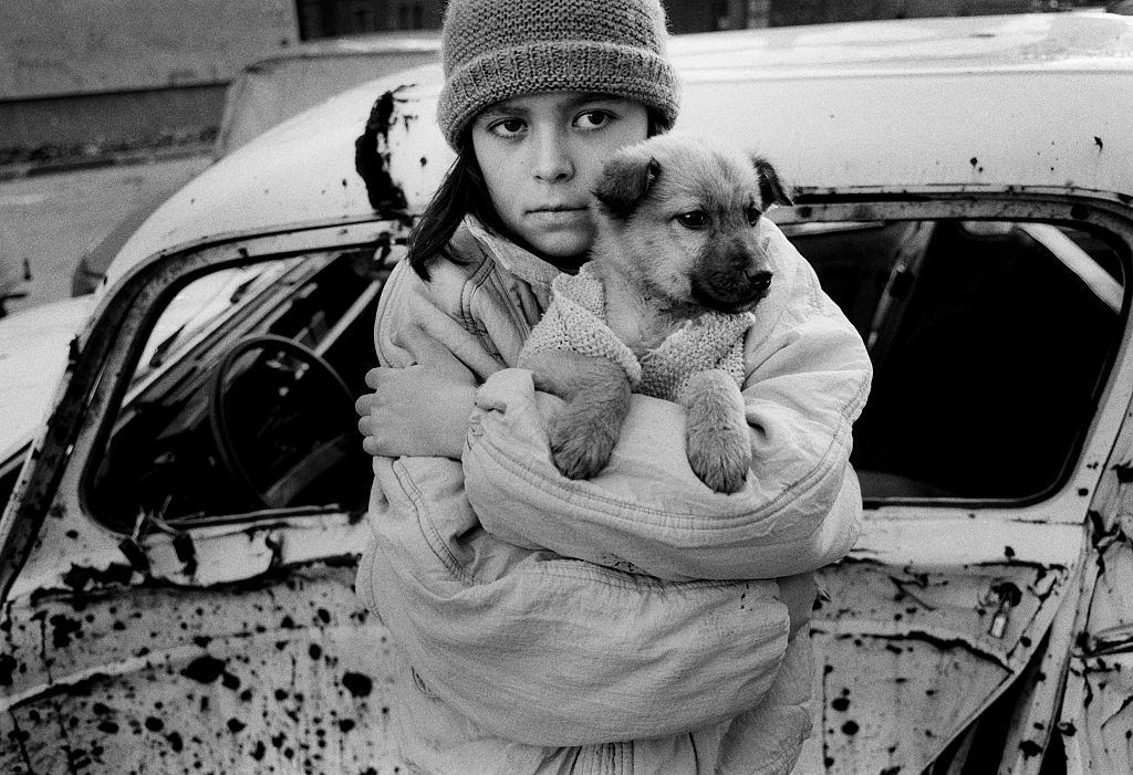 A Bosnian girl with her puppy, 1992.
