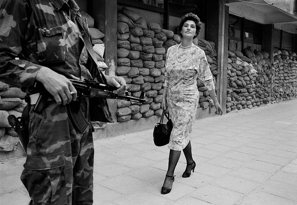 In the dangerous suburb of Dobrinja Meliha Vareshanovic walks proudly and defiantly to work during the siege of Sarajevo, 1993.