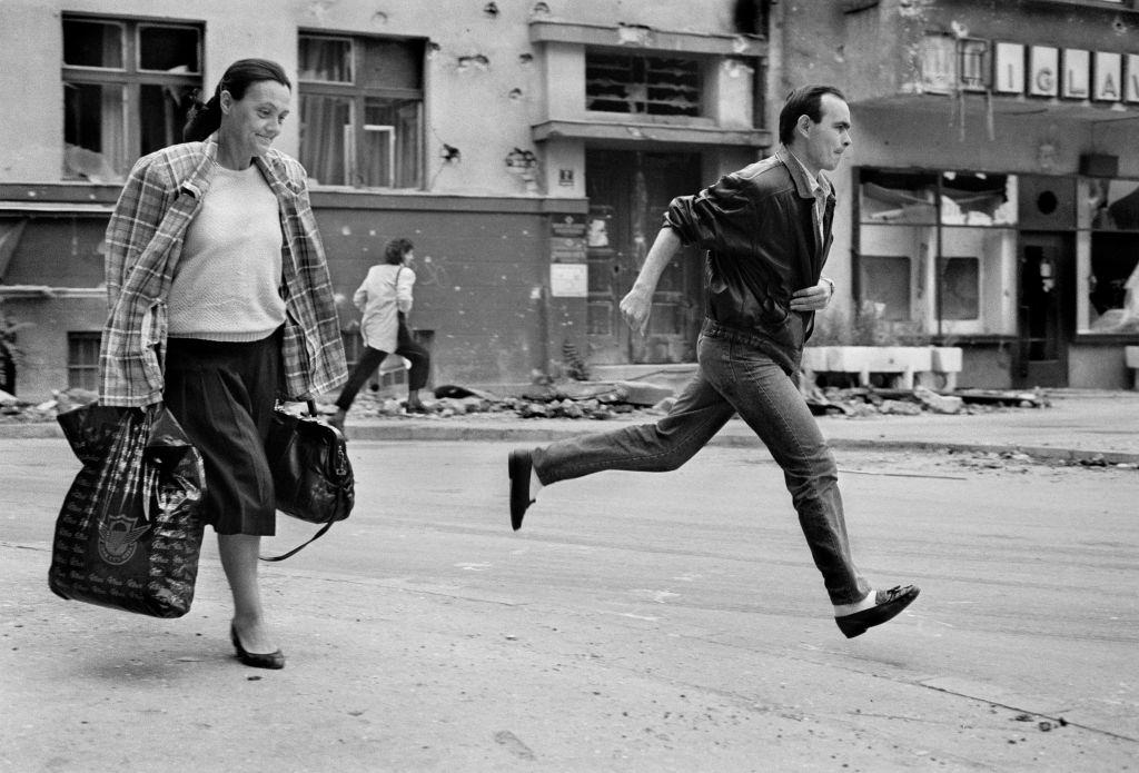 Citizens sprint across 'Sniper Alley' during the siege of Sarajevo in 1994.