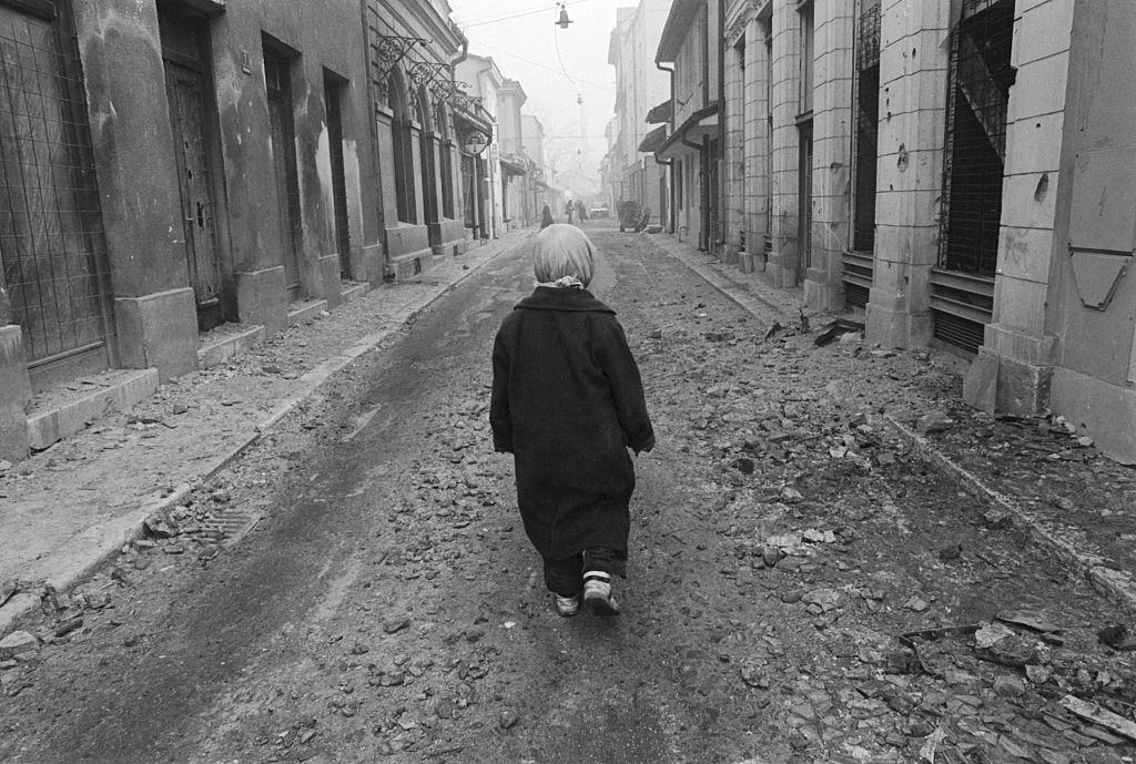 A 10-year-old Muslim boy, walks in the street. He survives in Sarajevo's Old Town.