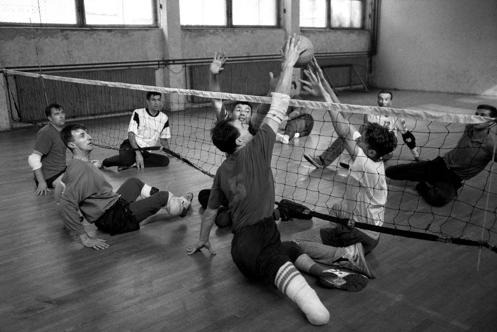 Men who lost limbs through shells and landmines play floor volley ball at a sports club for amputees set up in Sarajevo during the war, 1995.