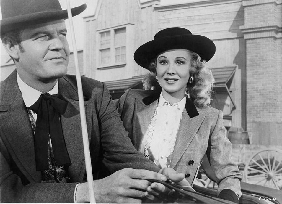 Virginia Mayo with Randolph Scott in a scene from the film 'Westbound', 1958.