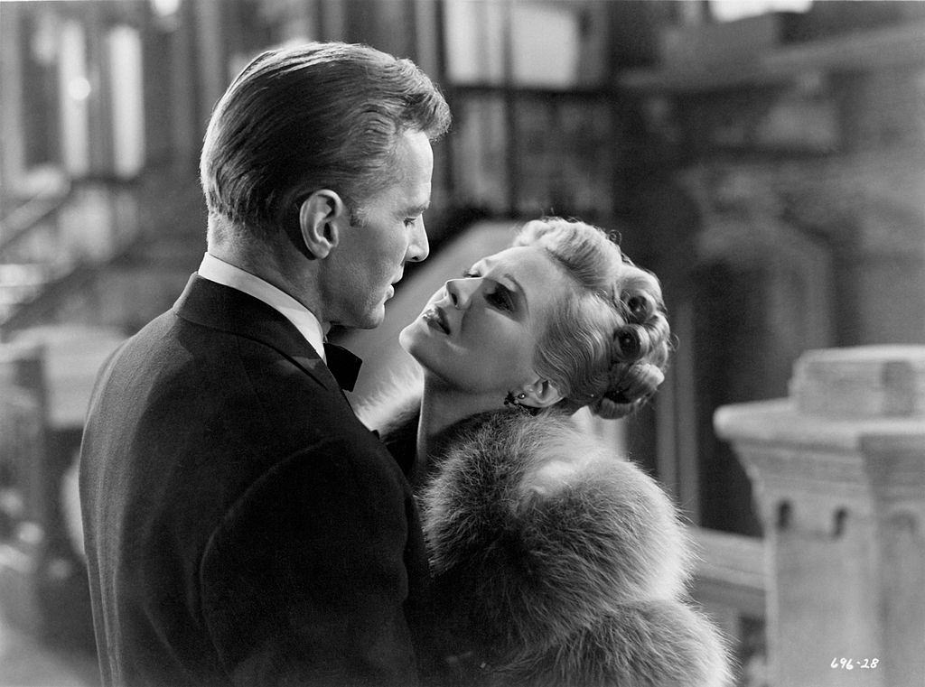 Virginia Mayo and Bruce Bennett embracing and looking intently into each other's eyes in a scene from the movie ''Smart Girls Don't Talk', 1948.