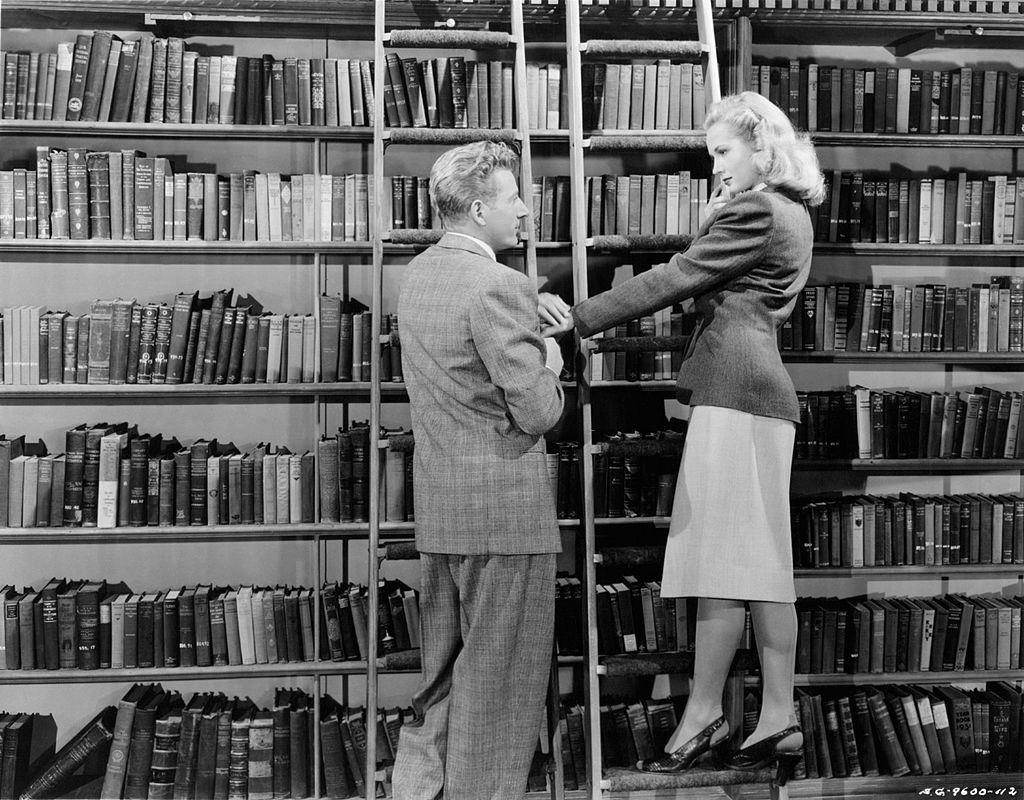 Virginia Mayo and Danny Kaye in a library in a scene from the movie 'Wonder Man', 1945.