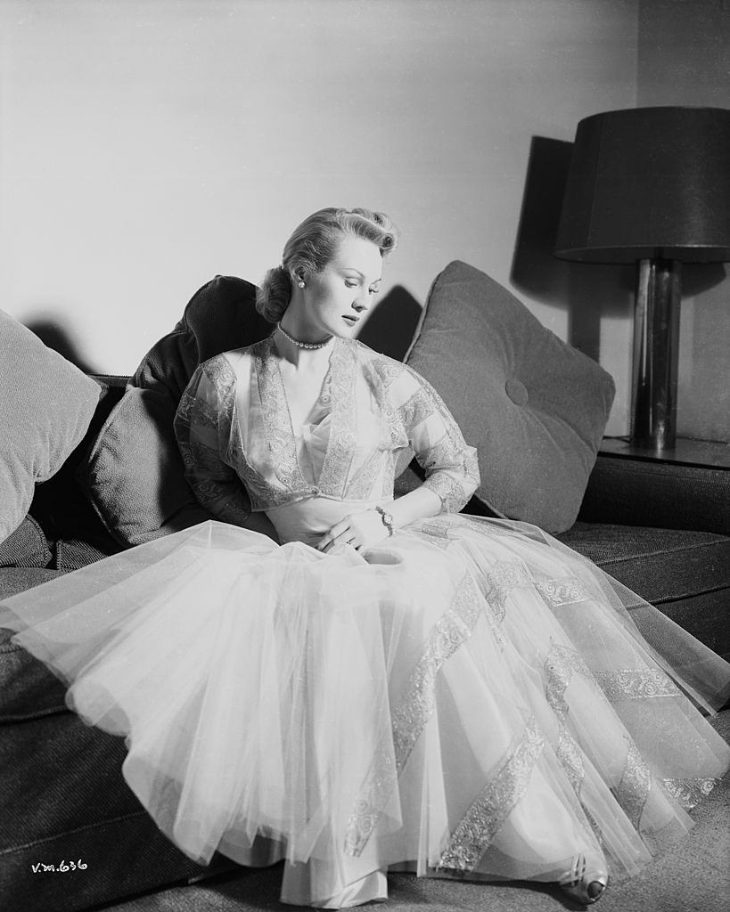 Virginia Mayo wearing an evening dress of layered gauze, 1950.