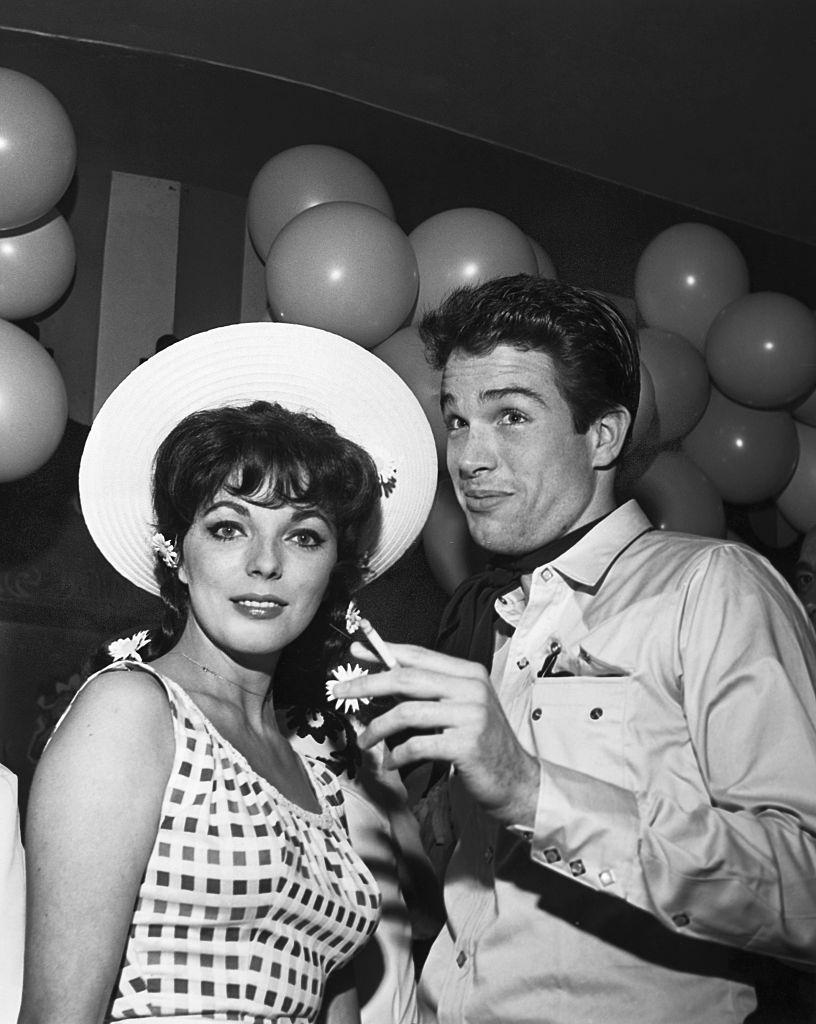 Warren Beatty with English actress and fiancee Joan Collins at a Hollywood charity event.